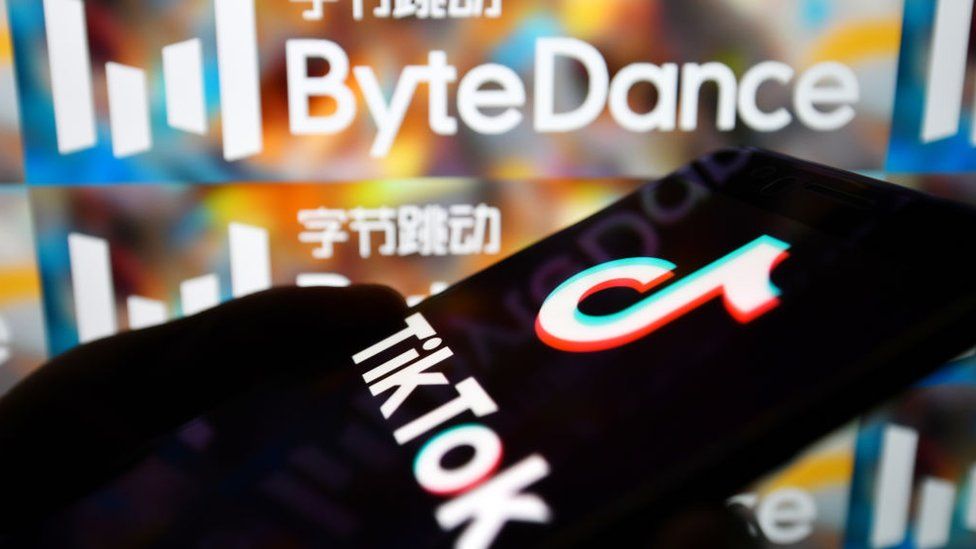 TikTok app on smartphone next to ByteDance logo