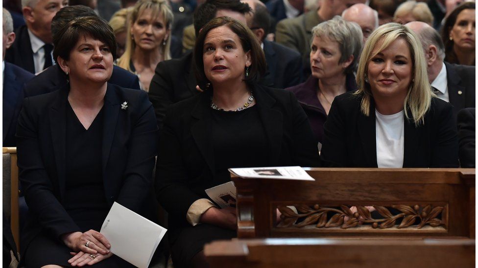 DUP leader, Arlene Foster, seated alongside leader of Sinn Féin, Mary Lou McDonald, and Sinn Féin Vice-President, Michelle O'Neill in St. Anne's Cathedral