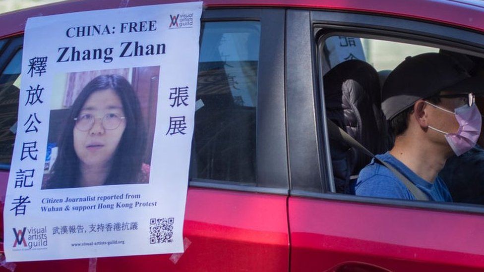 A car follows a funeral caravan with poster of Zhang Zhan, a Chinese citizen journalist who criticized the Chinese government's handling of the coronavirus crisis and is being held in a Shanghai prison