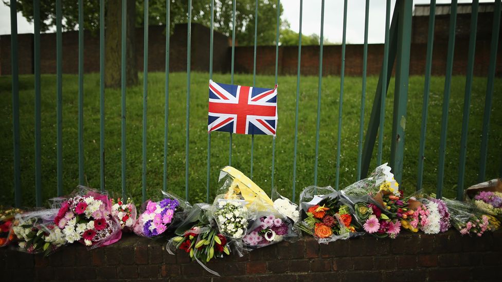 Flowers lay close to the scene where Drummer Lee Rigby of the 2nd Battalion the Royal Regiment of Fusiliers was killed, on May 24, 2013 in London, England.