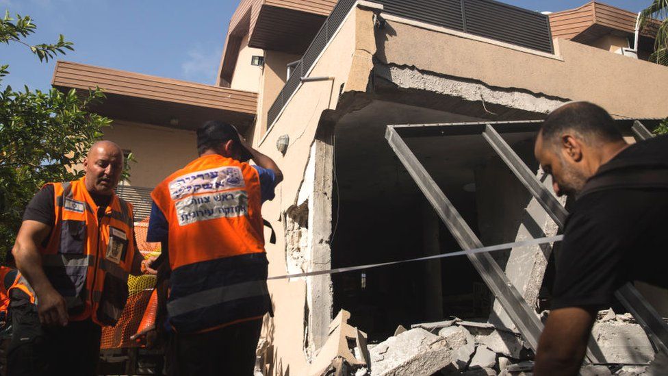 Israeli rescue team at damaged house