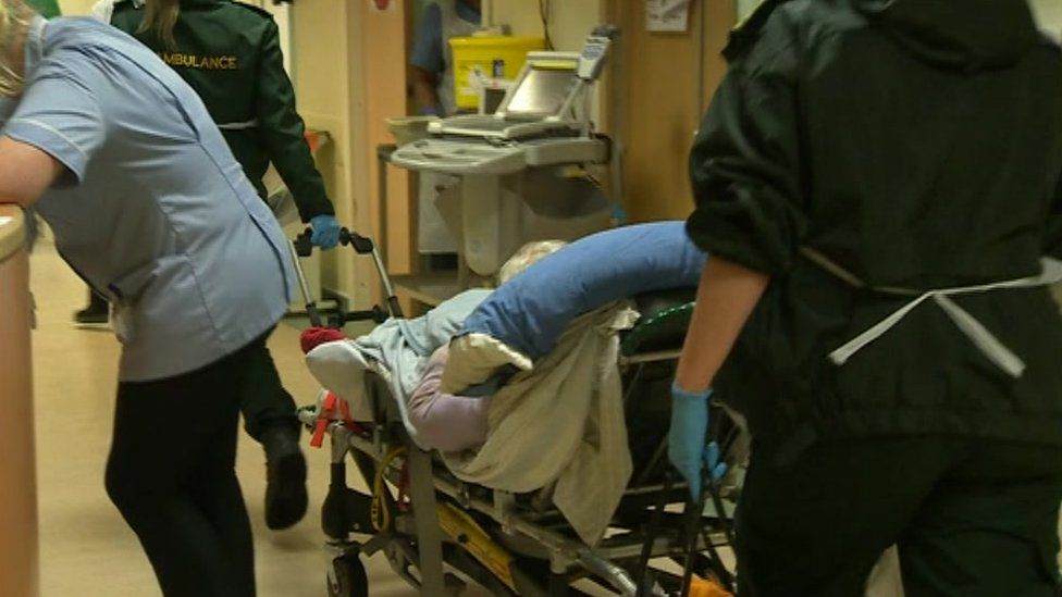 Ambulance paramedics bring a Covid patient to Royal Bournemouth Hospital