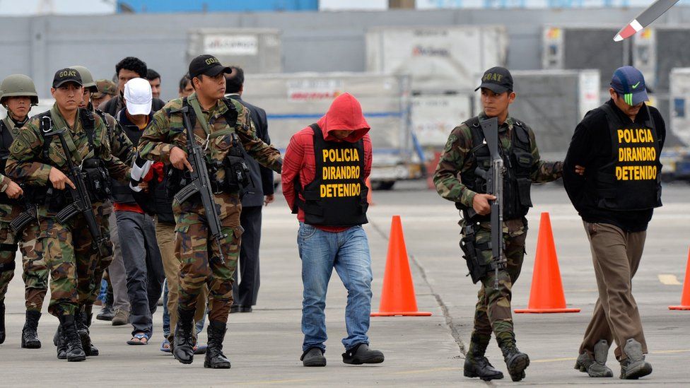 Police escort alleged drug smugglers