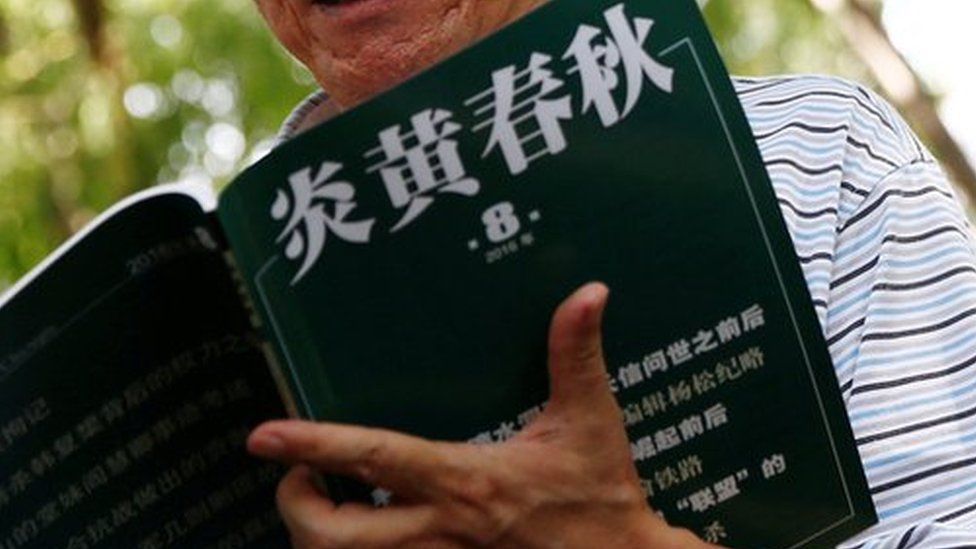 Wang Yanjun, former vice editor-in-chief of the liberal magazine Yanhuang Chunqiu, also known as China Through the Ages, holds an issue of the magazine as he speaks to the media outside the Chaoyang District Court in Beijing, China, August 16, 2016.