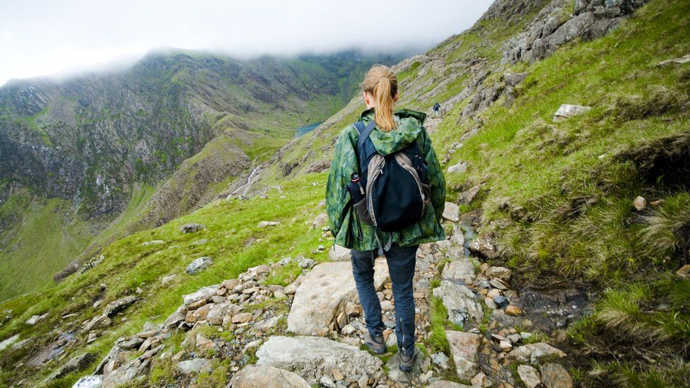 A woman descending a mountain in Snowdonia