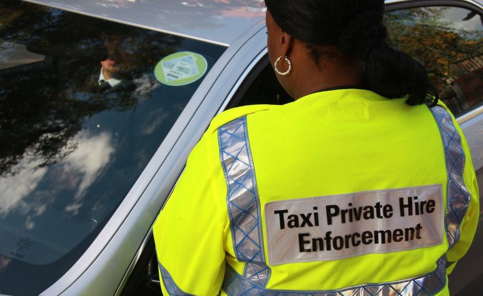 Taxi compliance officer and driver