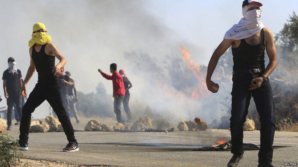 Protesters during clashes with Israeli troops following the funeral of Palestinian Saad Dawabsha in Duma near the West Bank city of Nablus on 8 August 2015