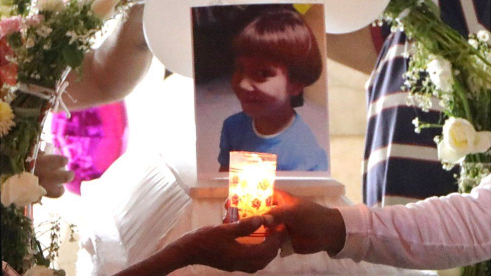 People light candles near the coffin of Fátima Aldrighett, 7, who went missing in Mexico City, 17 February 2020