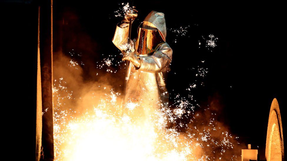 Steel worker takes a steel sample at a blast furnace in Duisburg, Germany