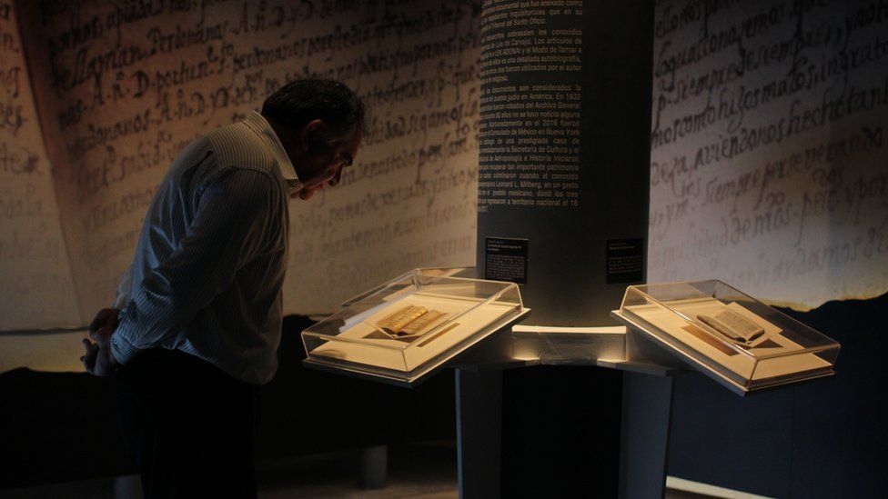 A man looks at the manuscripts at an exhibition
