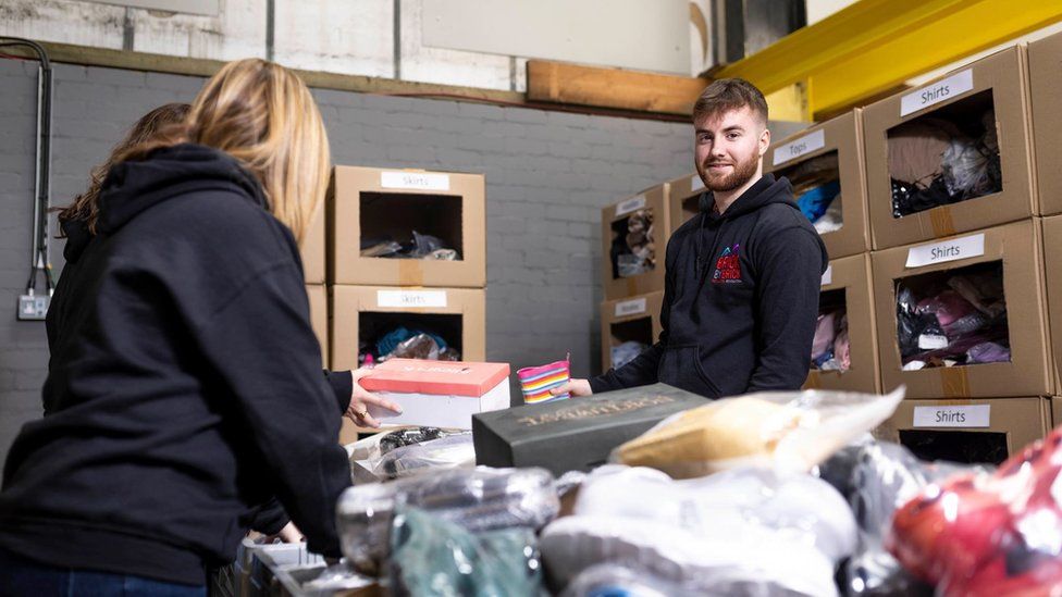 Man and woman sort donations