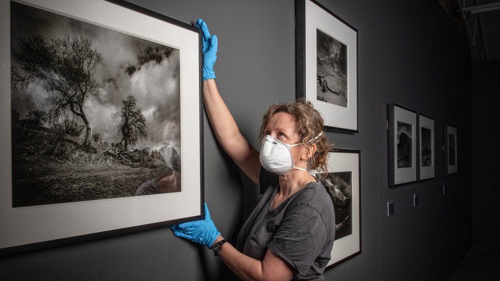 Art handling manager Jenny Hunter installing the Don McCullin exhibition at Tate Liverpool