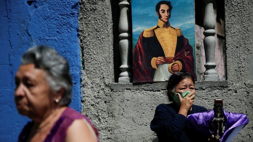 A woman wearing protective face mask reacts as The Nazarene of St Paul procession passed-by despite a nationwide quarantine due to the coronavirus disease (COVID-19) outbreak in Caracas, Venezuela April 8, 2020