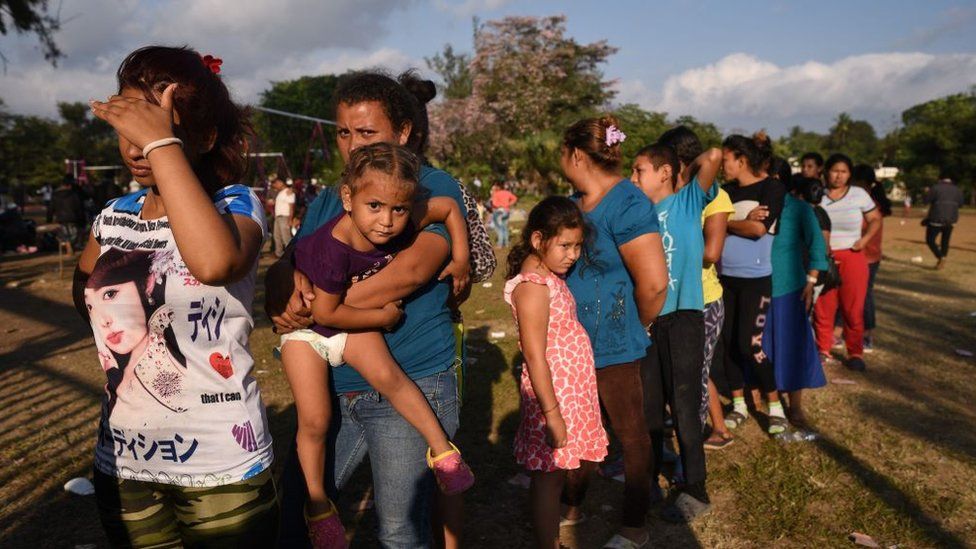 Migrants taking part in the caravan to the US queue for food in Oaxaca, Mexico on Tuesday