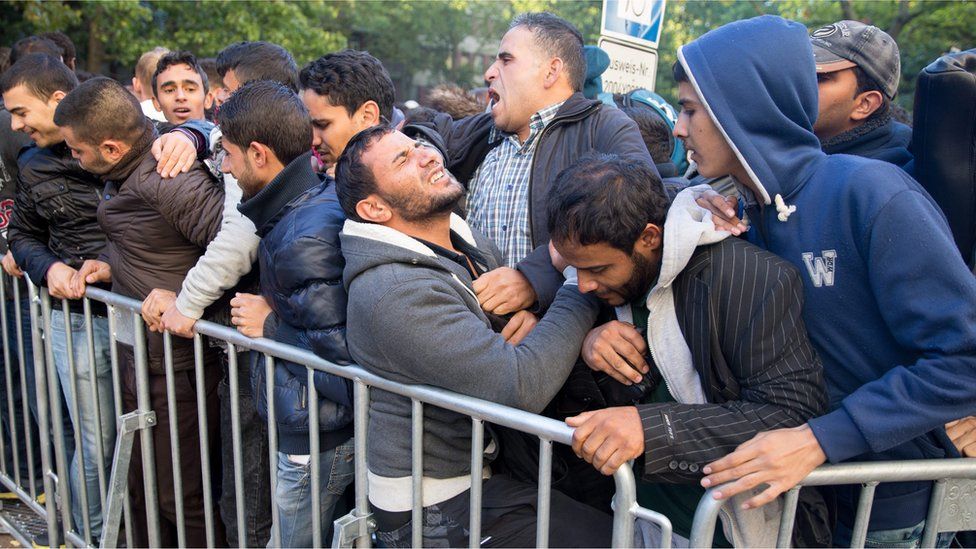 Migrants wait to be registered for accommodation in Berlin (29 Sept)