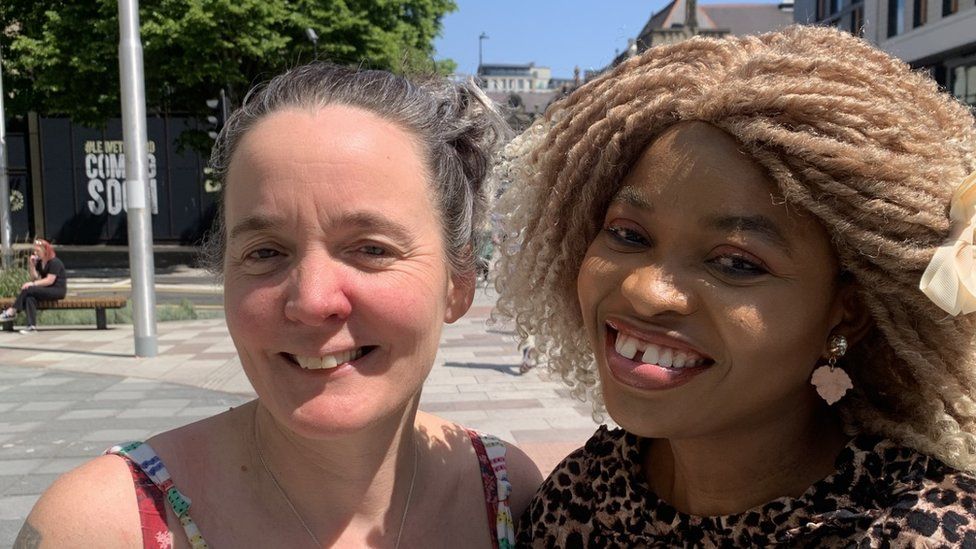 Cathryn McShane-Kouyaté and Tijesunimi Olakojo smiling in Cardiff town centre