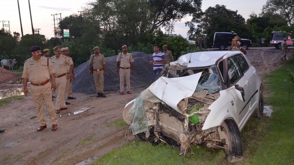 Police next to the crashed car in Uttar Pradesh (28 July 2019)