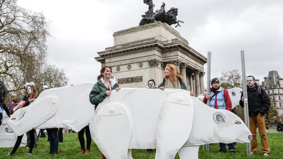 Greenpeace activists gather ahead of the London climate change march on 29 November 2015