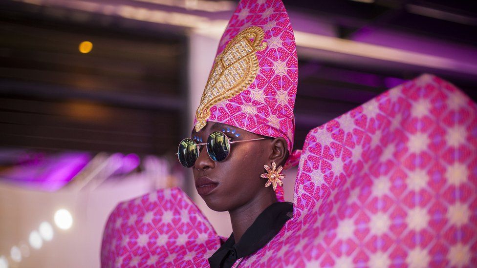 A model wearing a colourful pink design by Lupita Swagga during Dakar Fashion Week in Dakar, Senegal