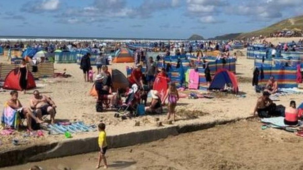 Perranporth beach in Cornwall full with beach-goers