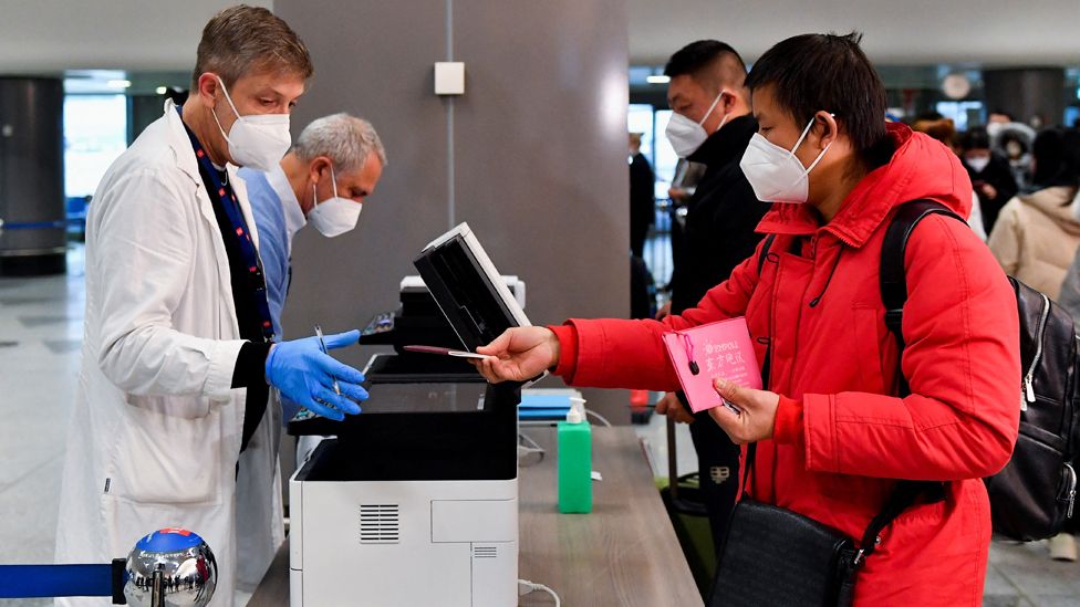 A rider  gives his passport to a worker, aft  Italy has ordered coronavirus illness  (COVID-19) antigen swabs and microorganism  sequencing for each  travellers coming from China, wherever  cases are surging, astatine  the Malpensa Airport successful  Milan, Italy, December 29, 2022.