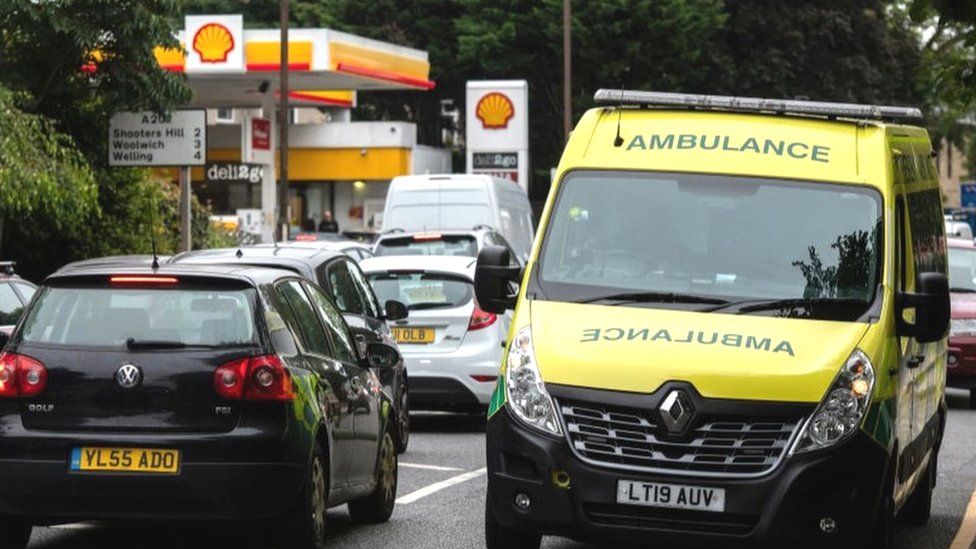 Ambulance leaving petrol station