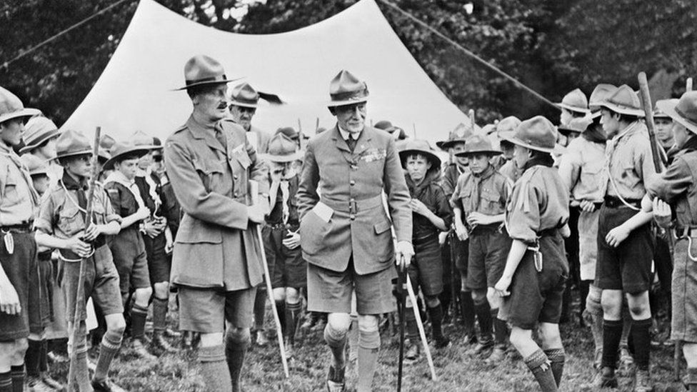 Baden-Powell (C-R) surrounded by the members of the Boy Scout movement