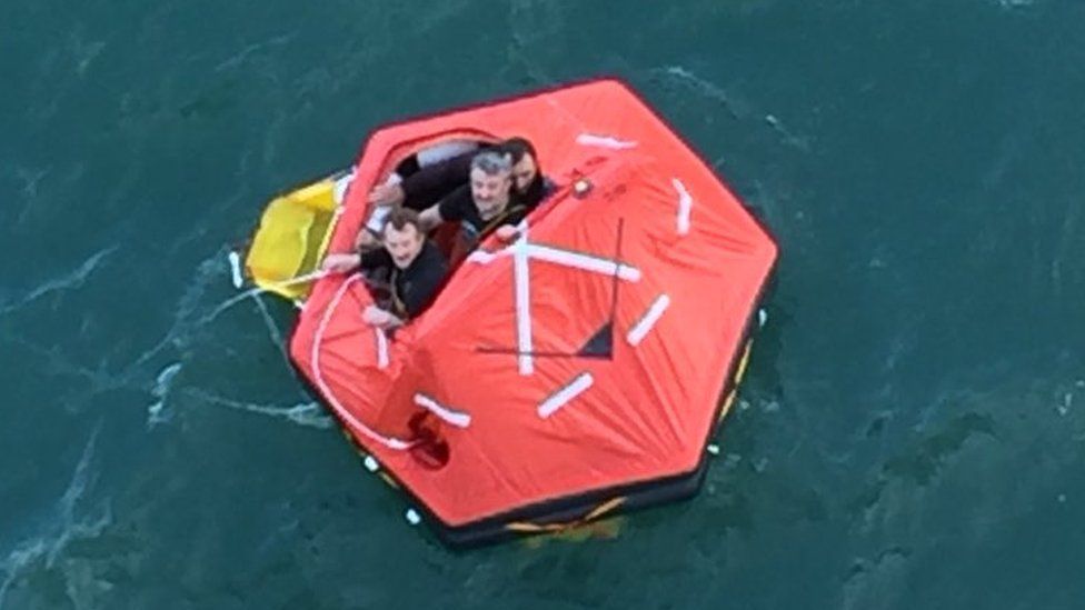 Three fishermen in a lifeboat who were rescued by crew from the Princess Cruise Lines" Pacific Princess as they drifted in the North Sea off the English coast
