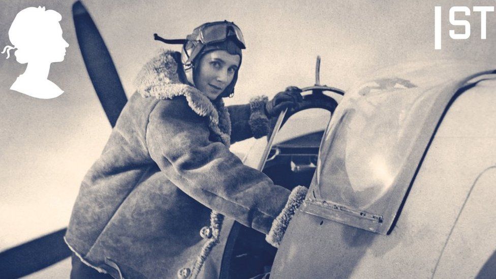 Female pilot climbing into cockpit of a spitfire