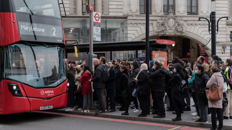 A bus stop queue outside Victoria Station