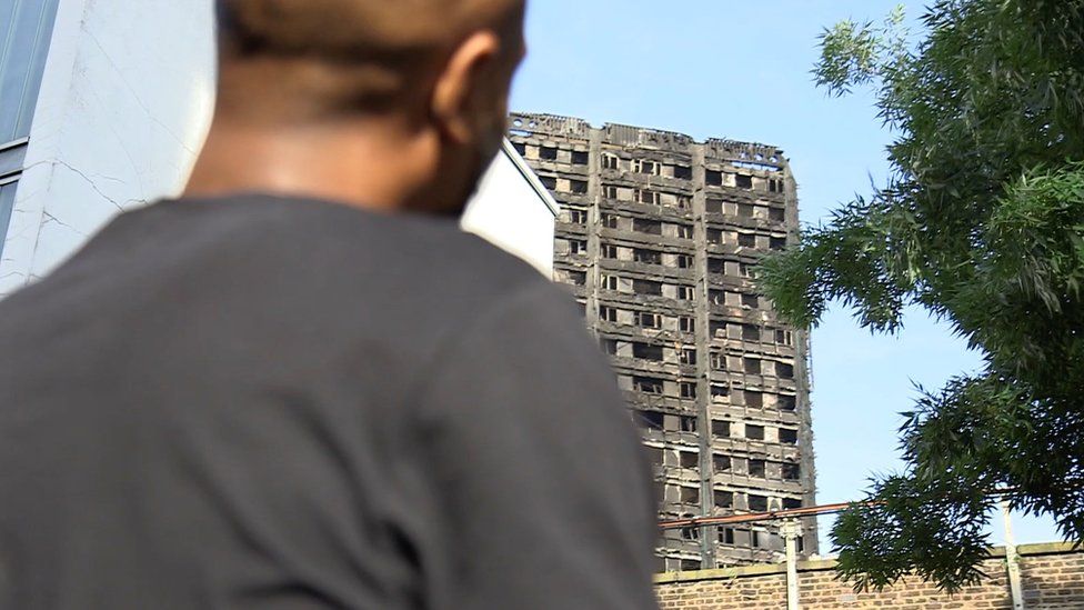 Olu looks at Grenfell Tower