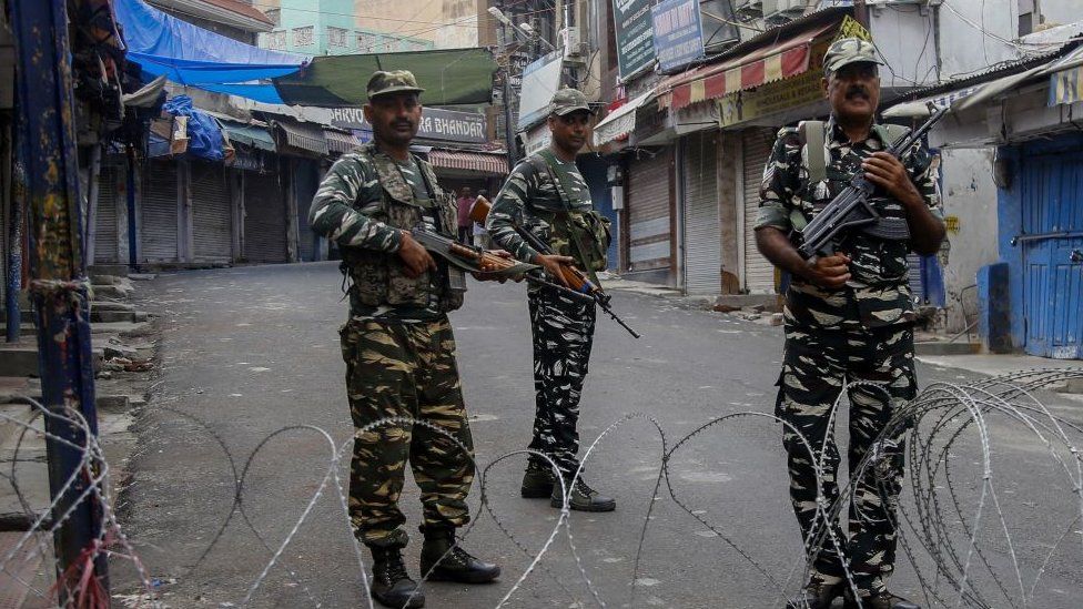 Security personnel stand guard at a roadblock ahead of Muslim's Friday noon prayers in Jammu.