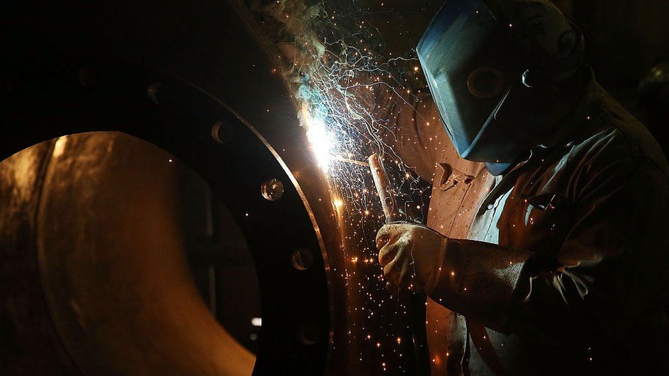Welder working on a tank for fracking