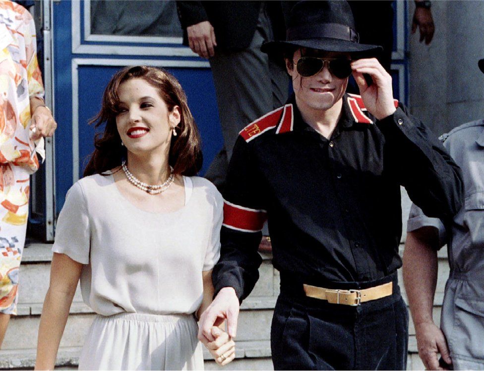 Pop star Michael Jackson and his bride Lisa Marie Presley-Jackson hold each others hands outside Heim Pal Children's Hospital where they distributed toys in Budapest, Hungary August 6, 1994
