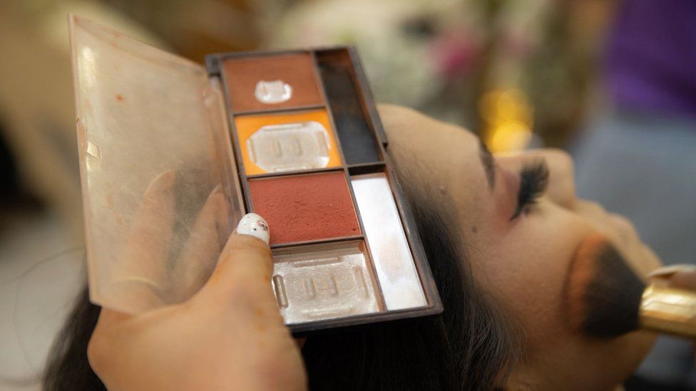 A women getting her make-up done in Afghanistan