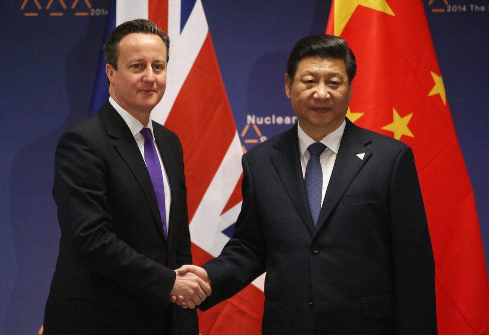 British Prime Minister David Cameron (L) shakes hands with Chinese President Xi Jinping before bilateral talks at the 2014 Nuclear Security Summit on 25 March 2014 in The Hague, Netherlands.