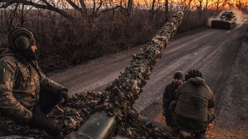 Ukrainian troops on a tank preparing for battle