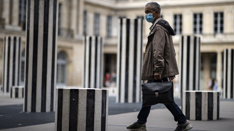 man walks through paris art installation