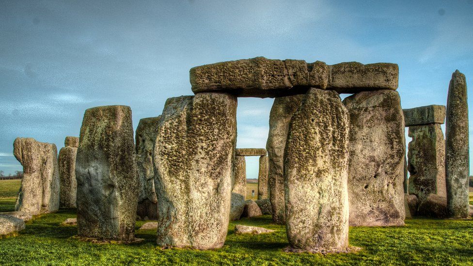 The standing stones of Stonehenge, pictured against a stormy-looking sky