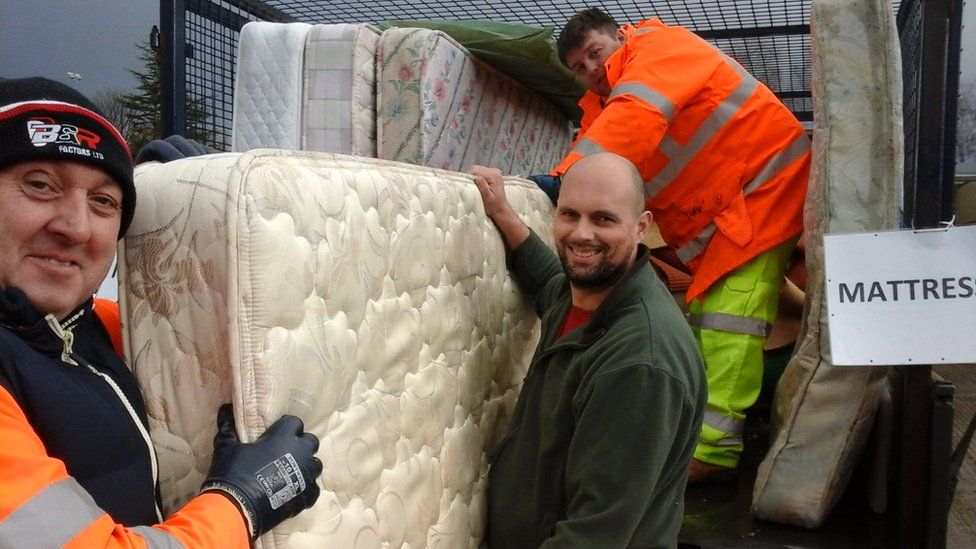 Photo of council staff collecting old mattresses