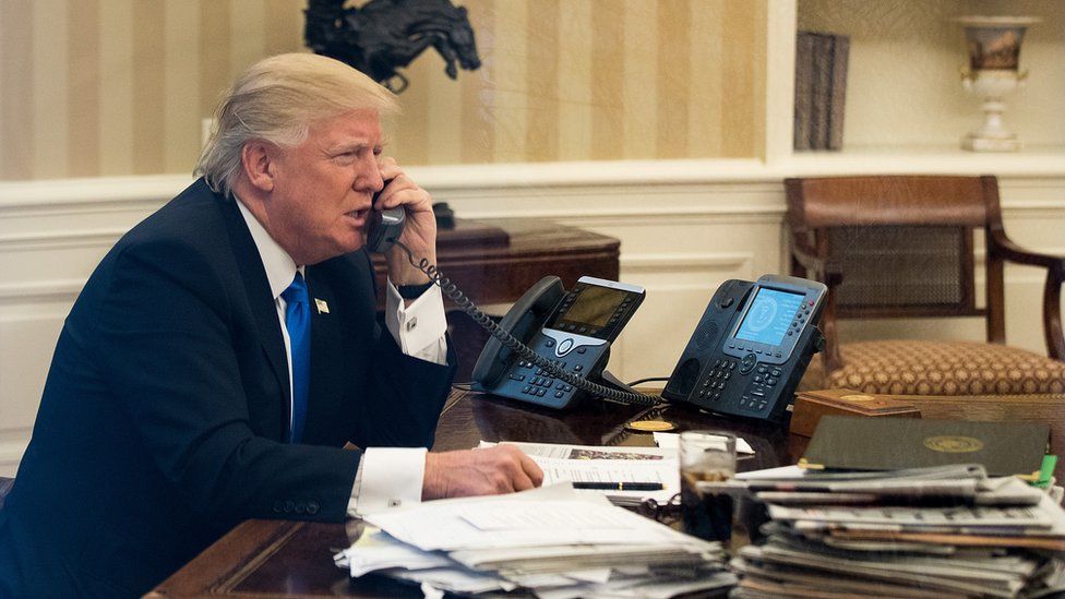 Donald Trump on the phone in the Oval Office.