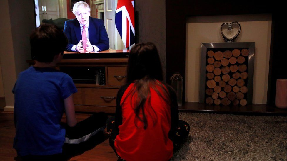 Children watch Boris Johnson on TV