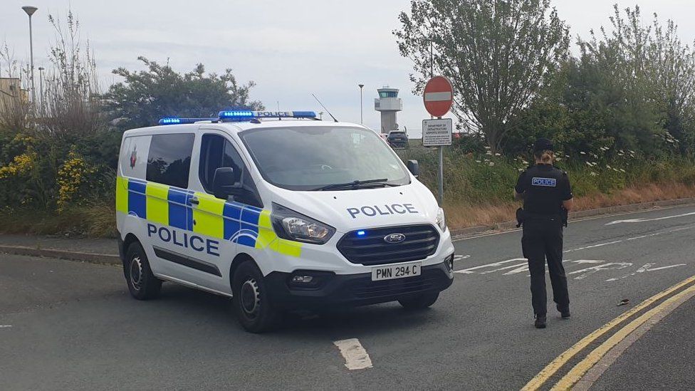 Police van blocking airport road