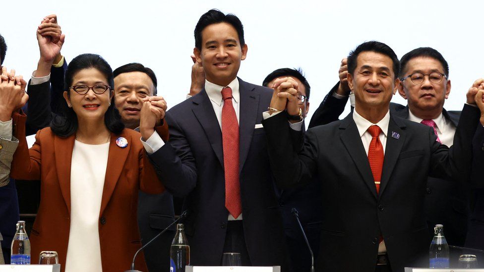 Pita Limjaorenrat of Thailand's Move Forward Party waves to cameras after unveiling his coalition