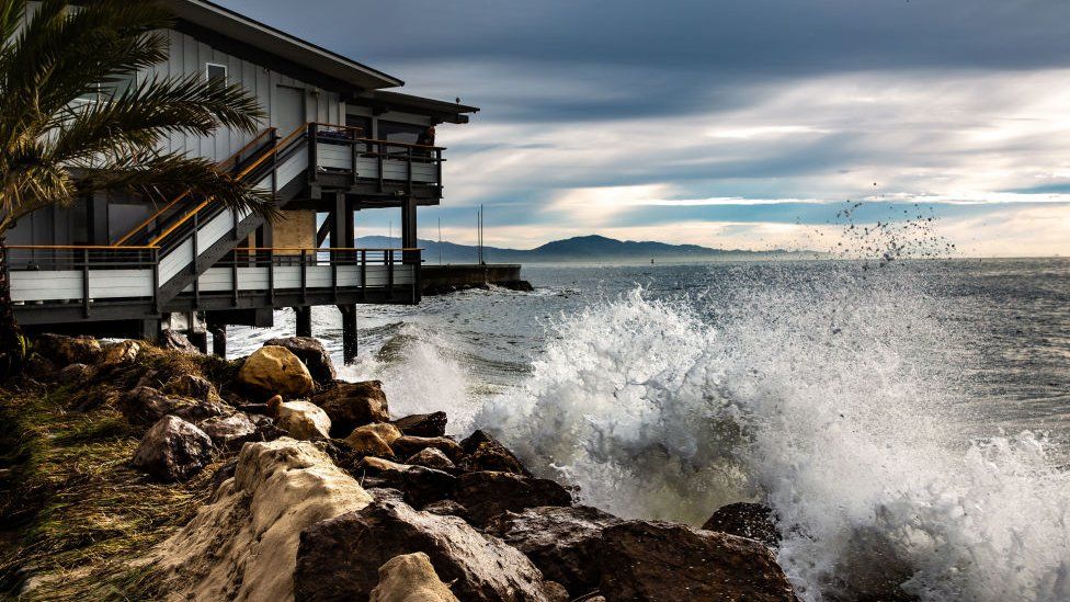 A beach house battered by storms