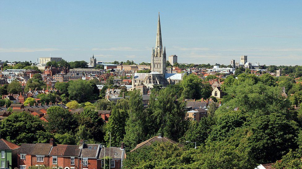 Elevated view of Norwich with the city's cathedral in the background