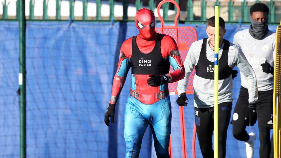 A football player dressed as Spiderman