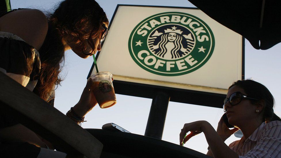 Two women drink Starbucks in Miami