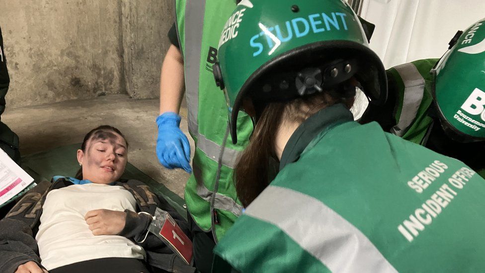Students treat injured woman in mock zombie exercise