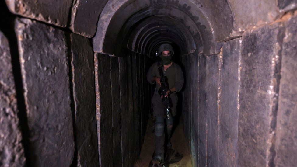An IDF soldier walks through a captured Hamas tunnel